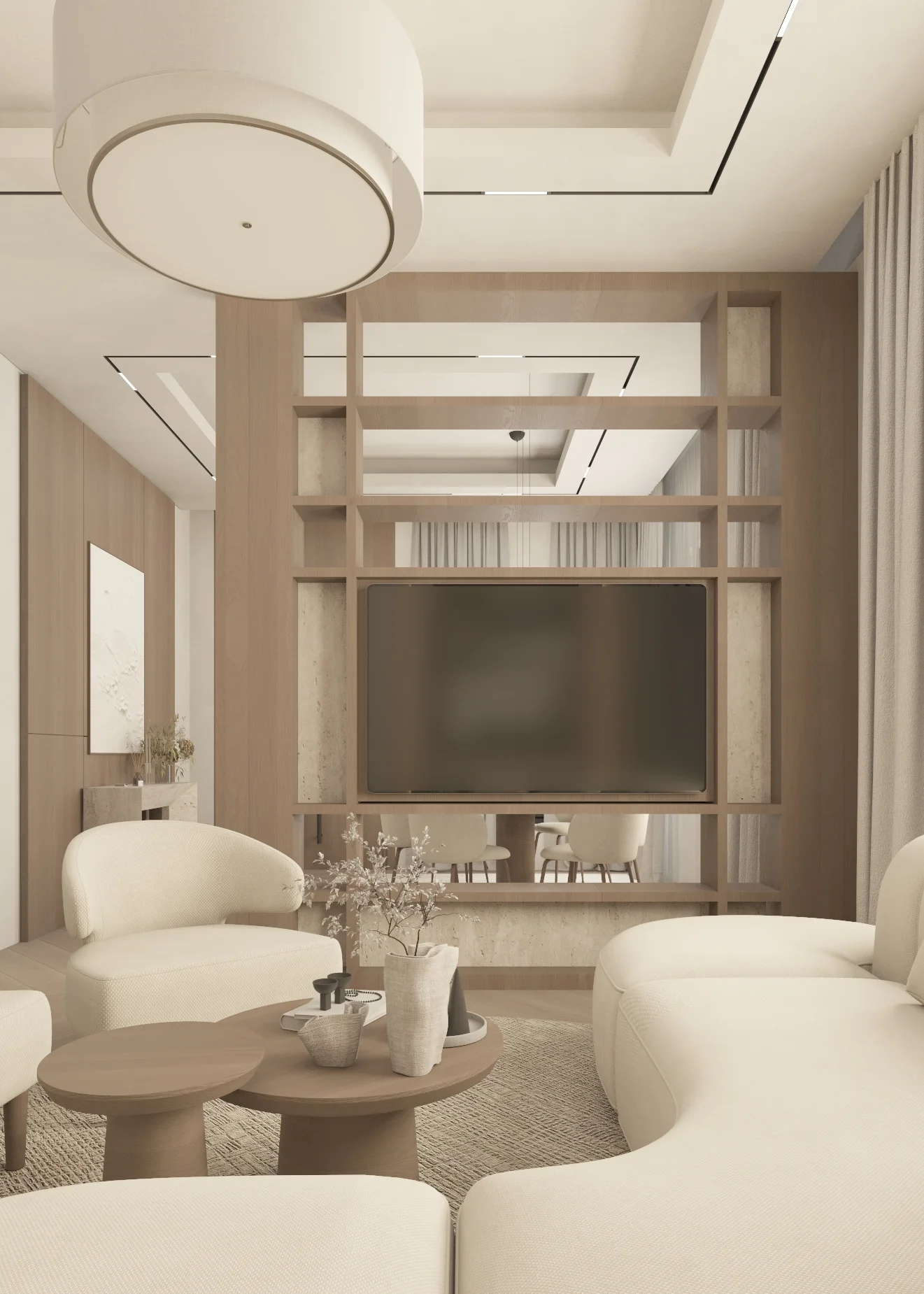 View through curved armchairs to the television, open shelving and softly illuminated joinery.