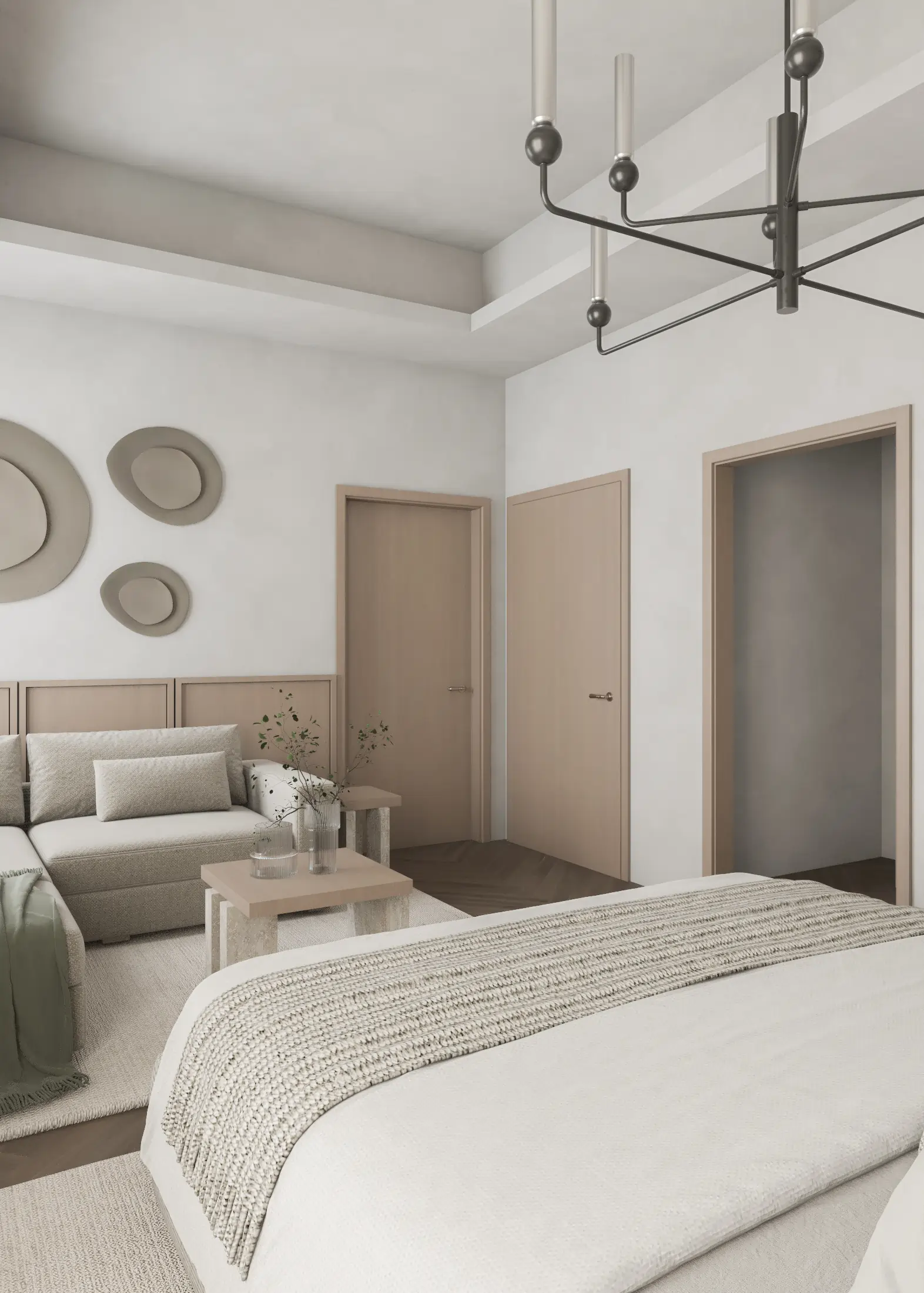 View across the upholstered bed toward the suite’s sofa, low table and adjoining doors.