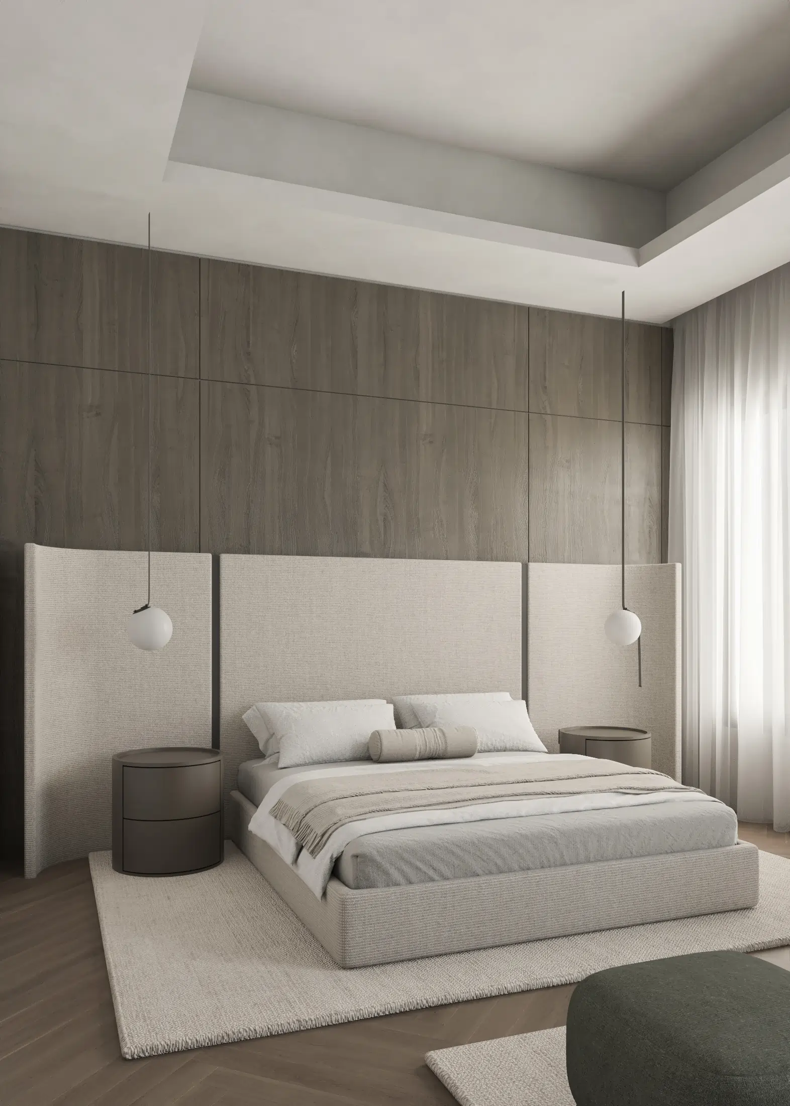 Angled bedroom view with the upholstered bed, dark timber headboard and a rounded green ottoman.