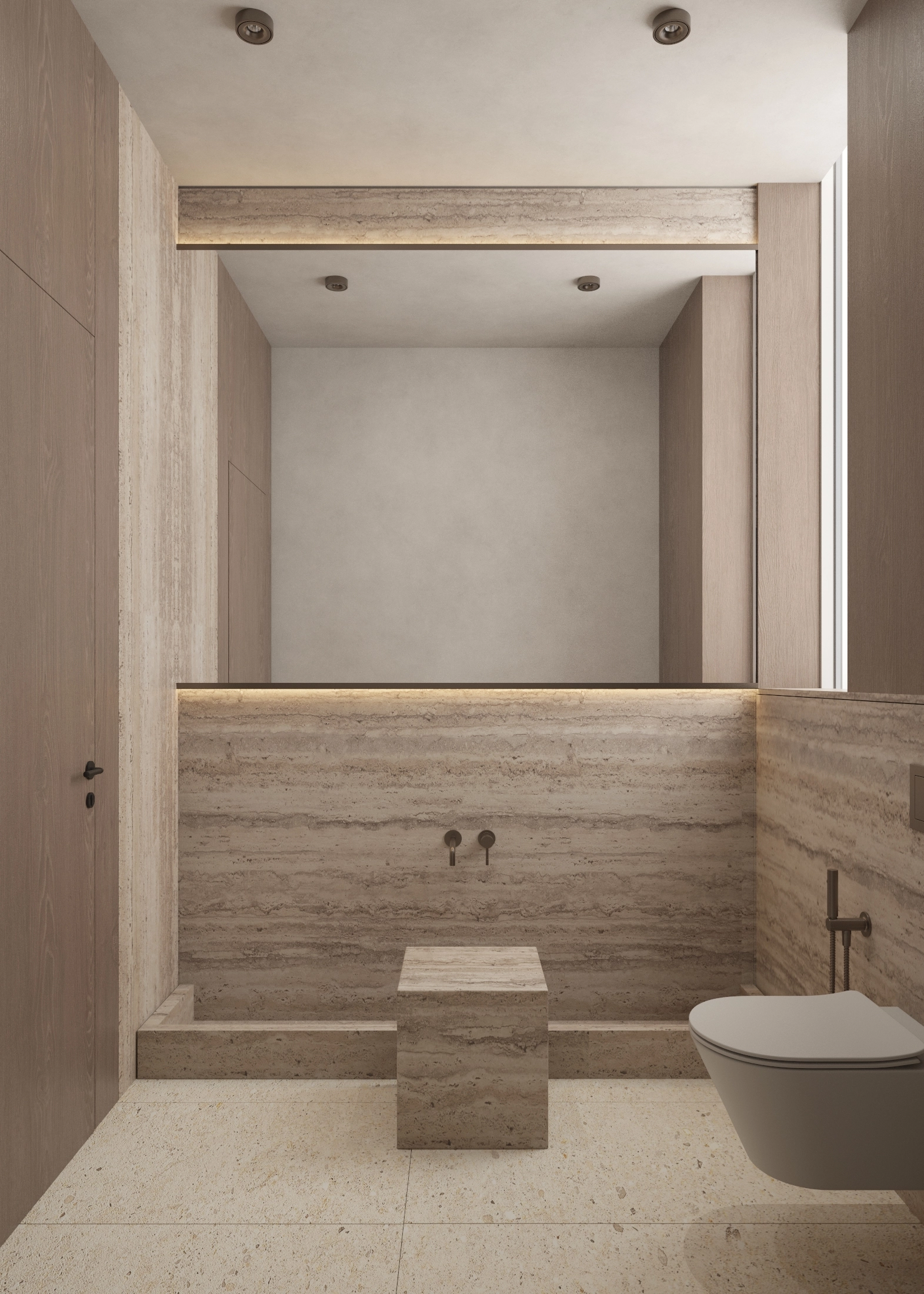 Front view of a stone-lined bath, mirror and wall-mounted toilet