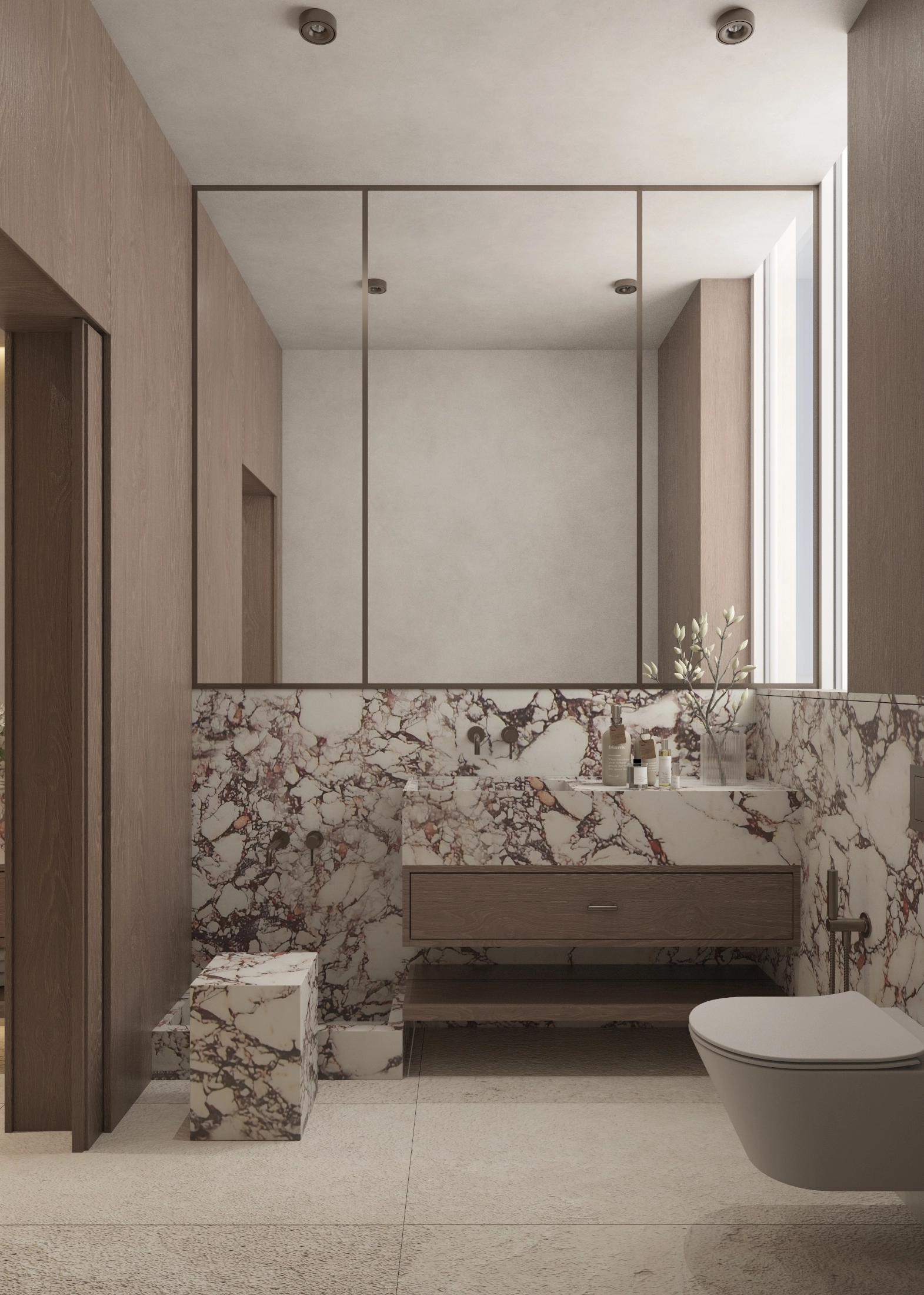 Alternate view of the marble vanity, broad mirror and wall-mounted toilet