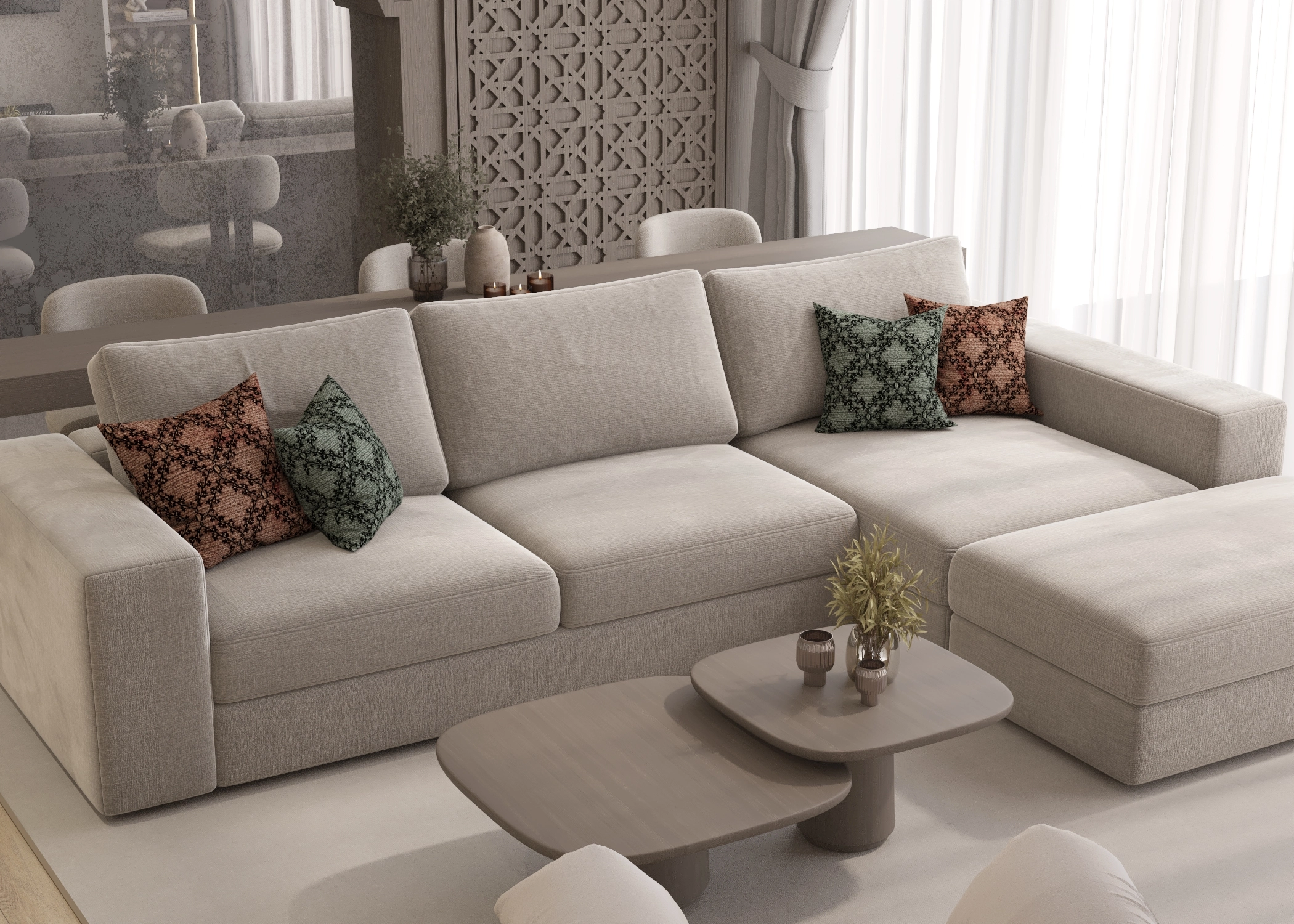 Living room seating detail with a pale sectional, patterned cushions and rounded nesting tables