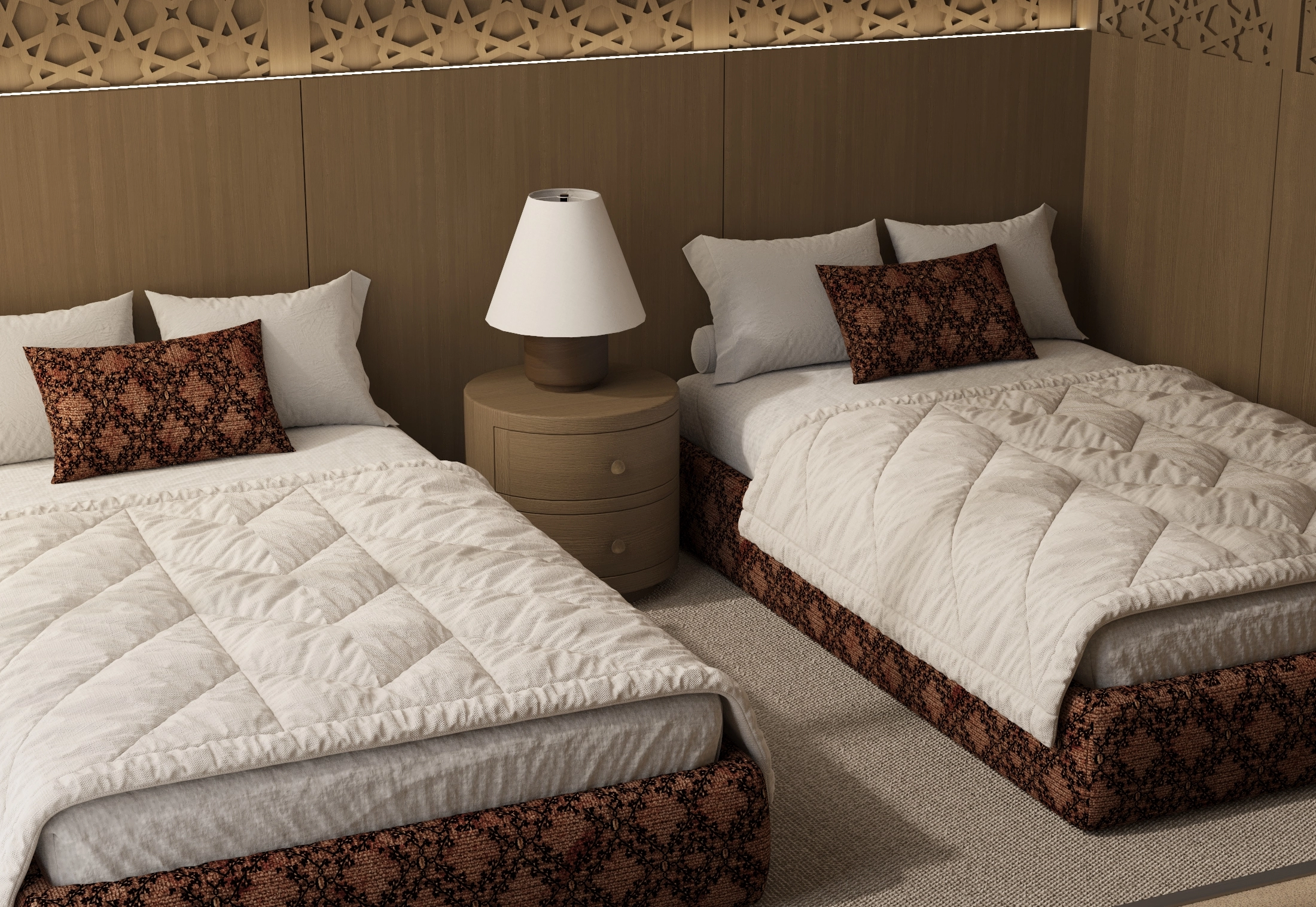 Twin bedroom bedding detail with a shared round nightstand, lamp and warm patterned upholstery