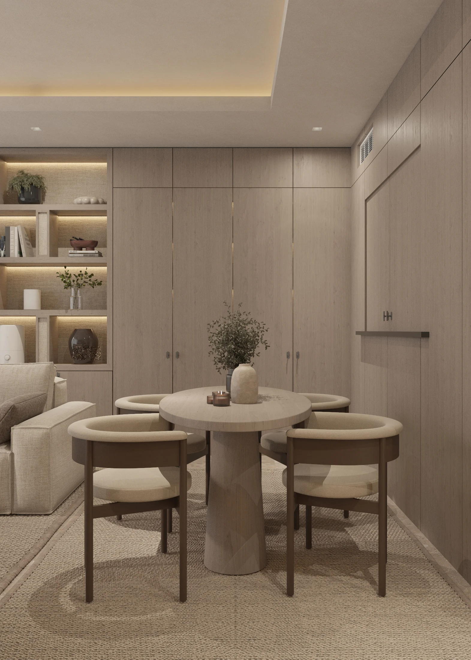 Round dining table with four upholstered chairs set before flush full-height timber cabinetry