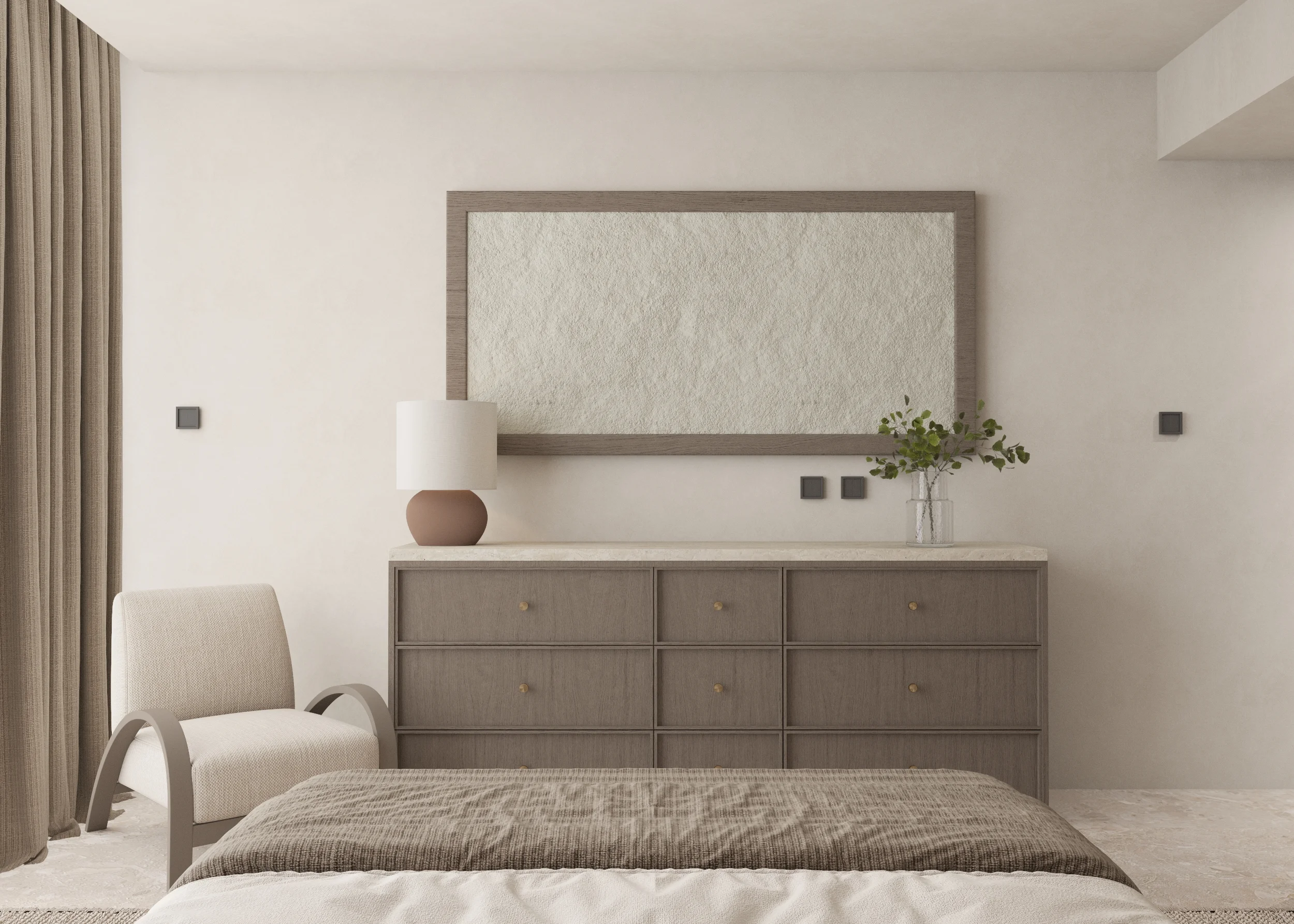 View from the foot of the bed toward a long drawer chest, arched chair, table lamp and framed textured panel