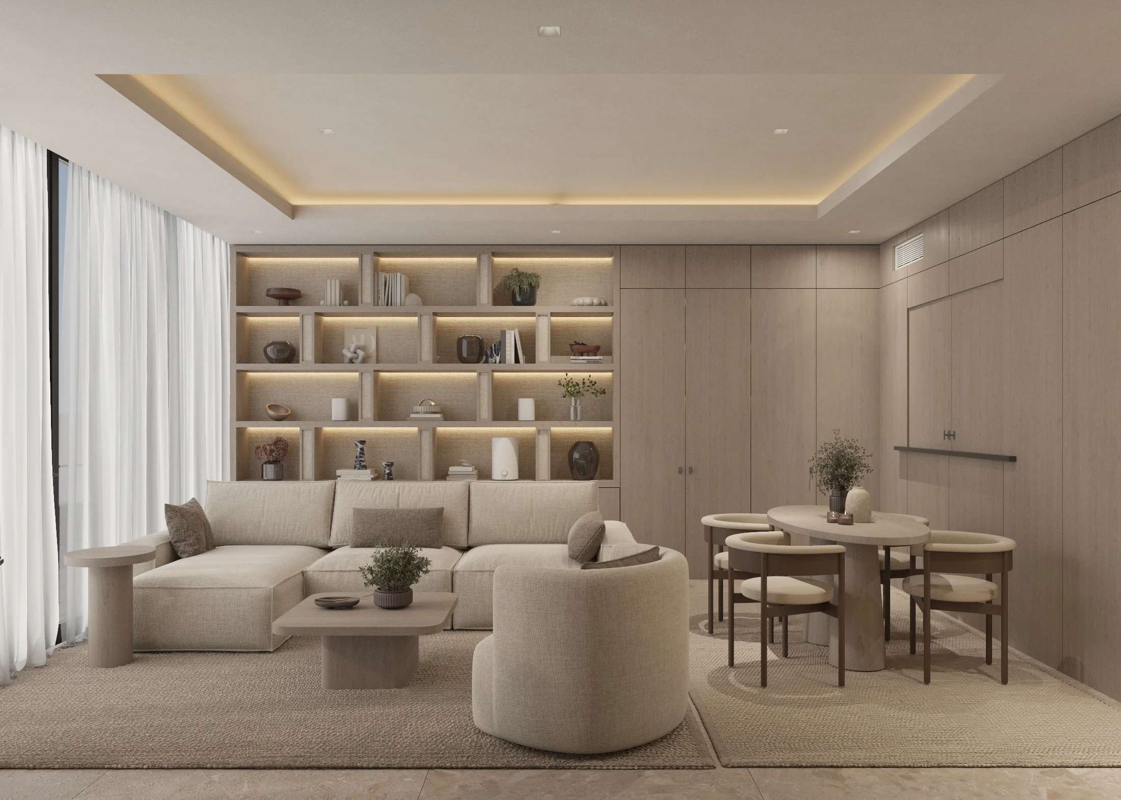 Wide living and dining room with a pale sectional, round table and flush timber cabinetry concealing the work niche
