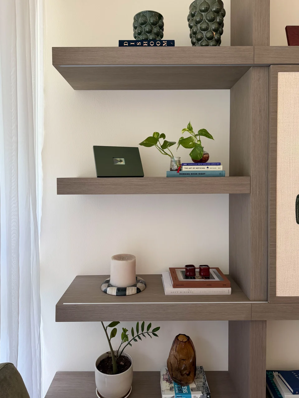 Left open shelving and styling beside the living-room curtain