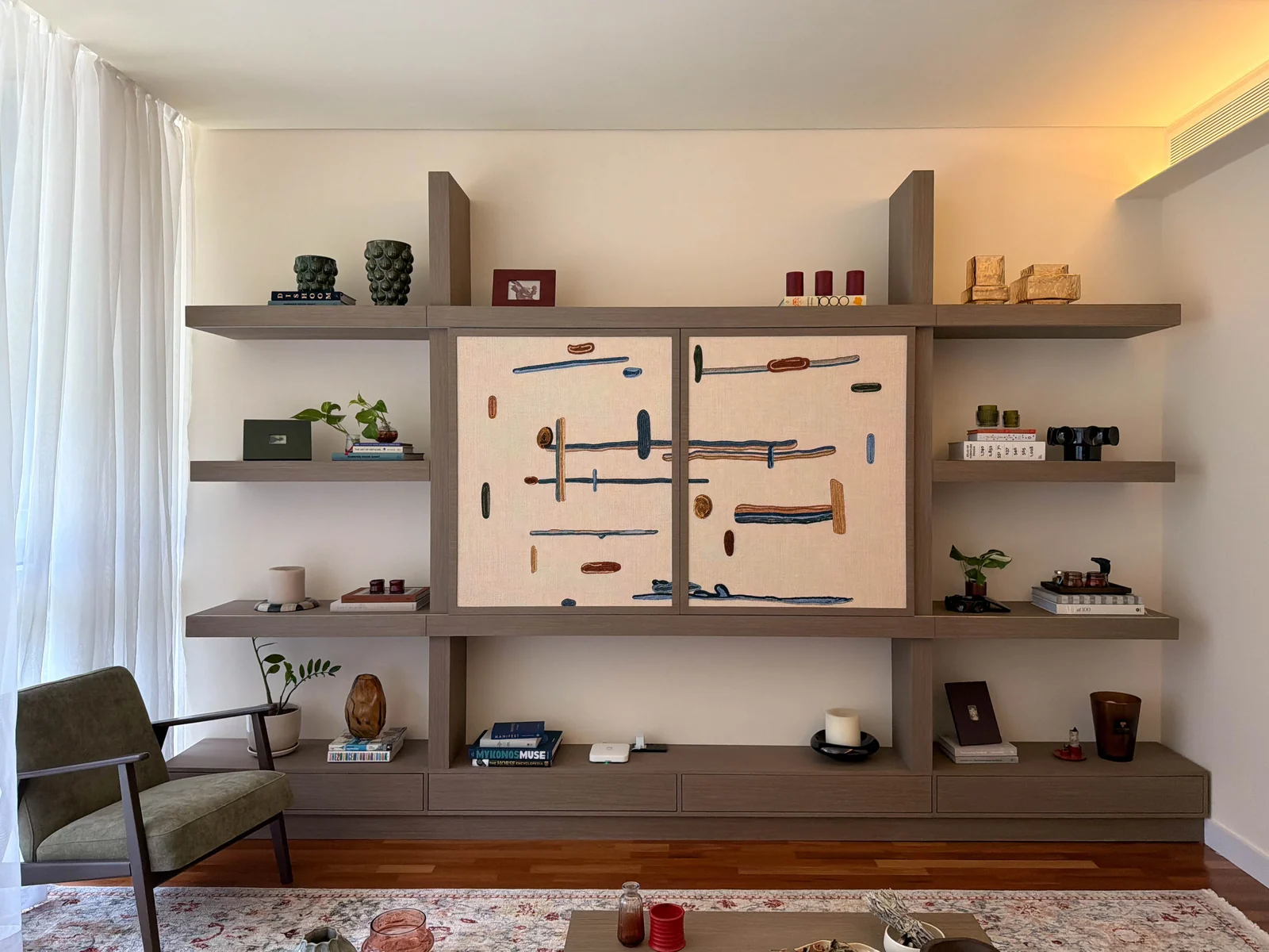 Completed City Walk Apartment media wall with closed patterned panels and timber shelving