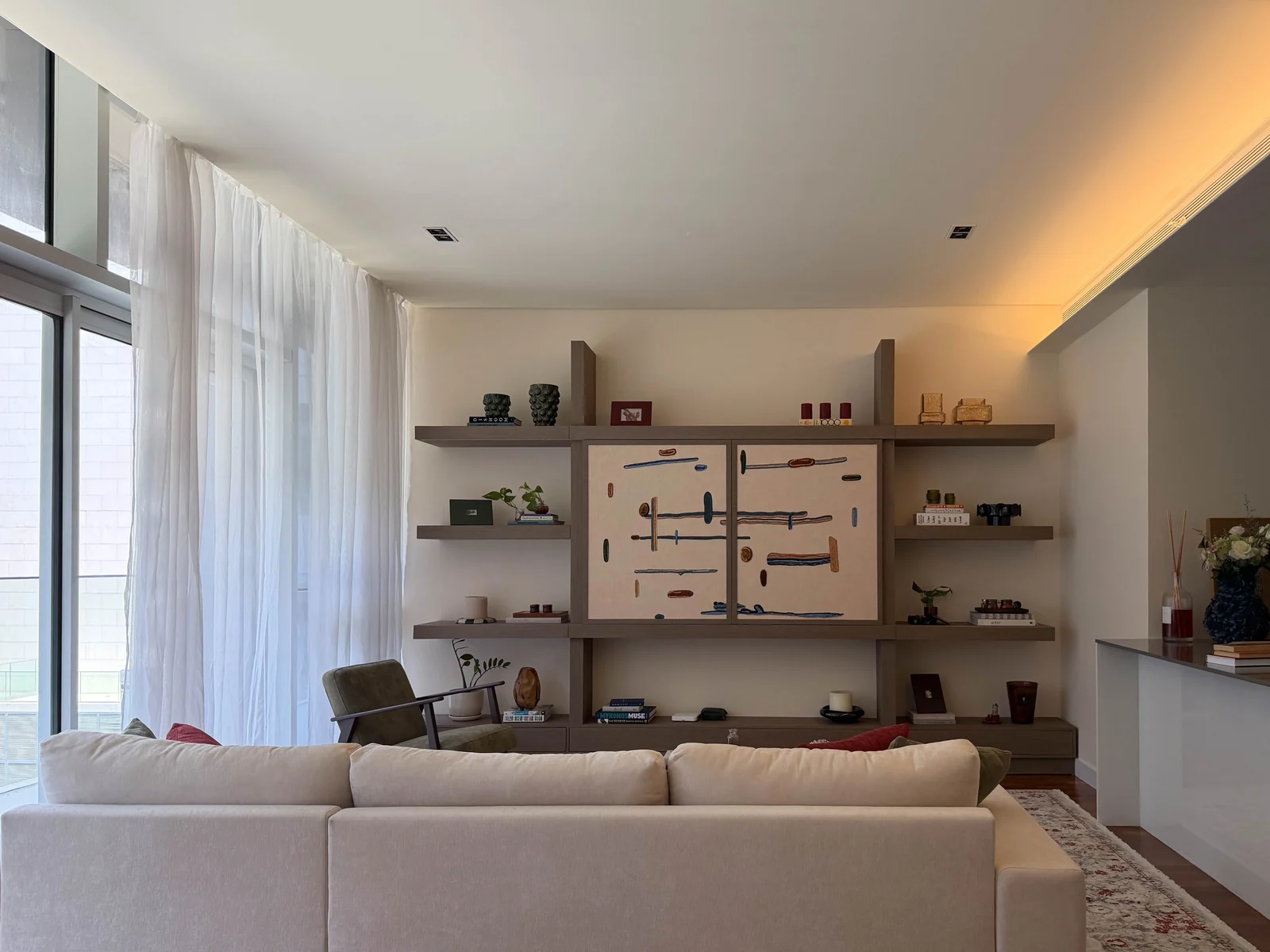 Completed media wall viewed across the City Walk Apartment living-room seating