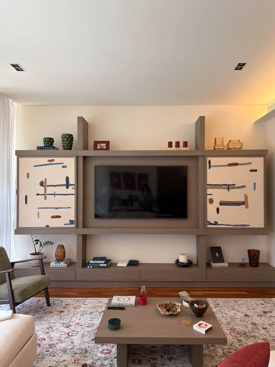 Portrait view of the completed media wall with the television revealed