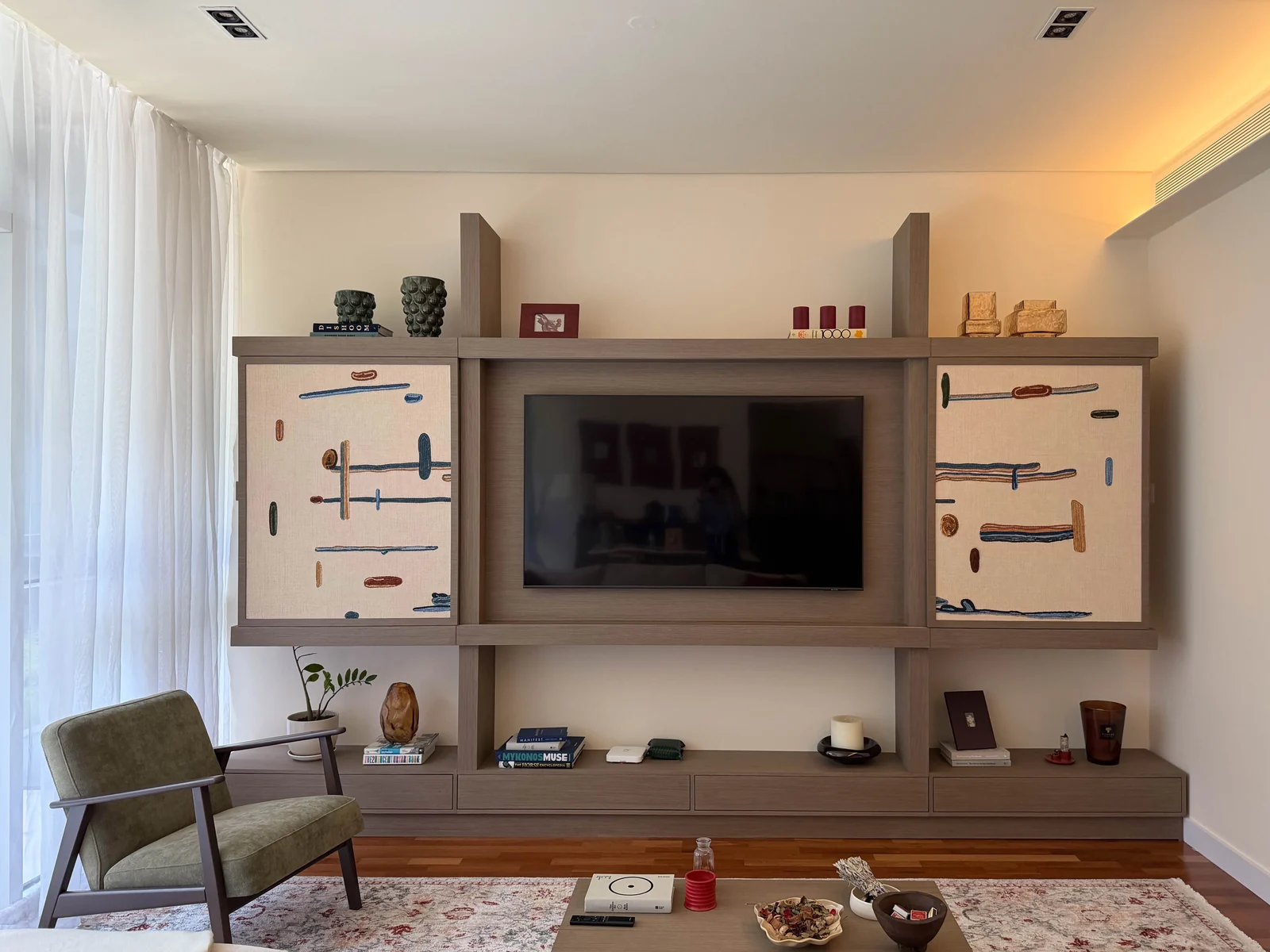 Television revealed within the completed timber media wall at City Walk Apartment