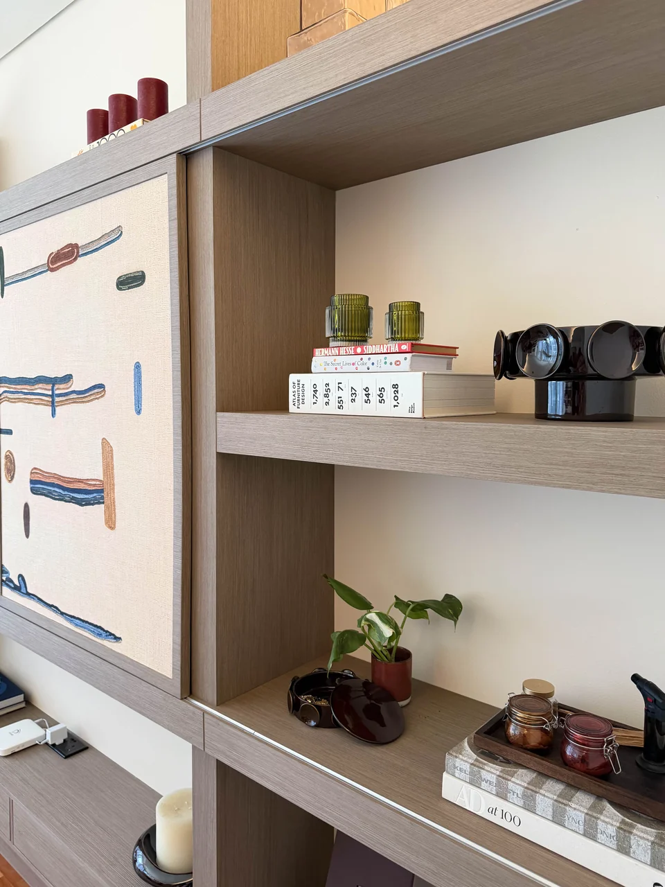 Angled joinery view of a patterned panel and open timber display shelves