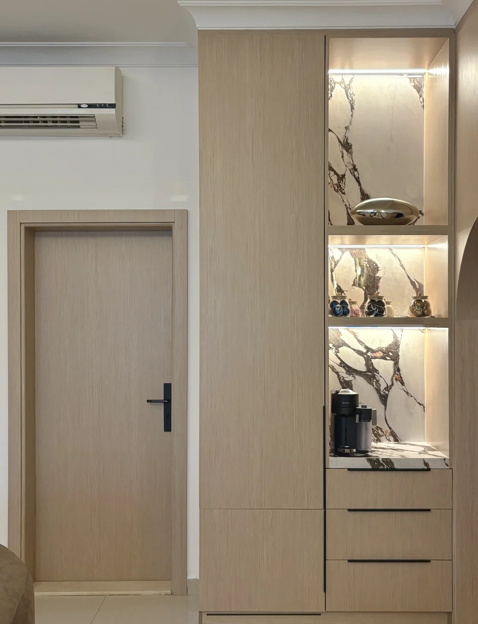 Completed Mirdif villa doorway with illuminated marble-backed coffee station