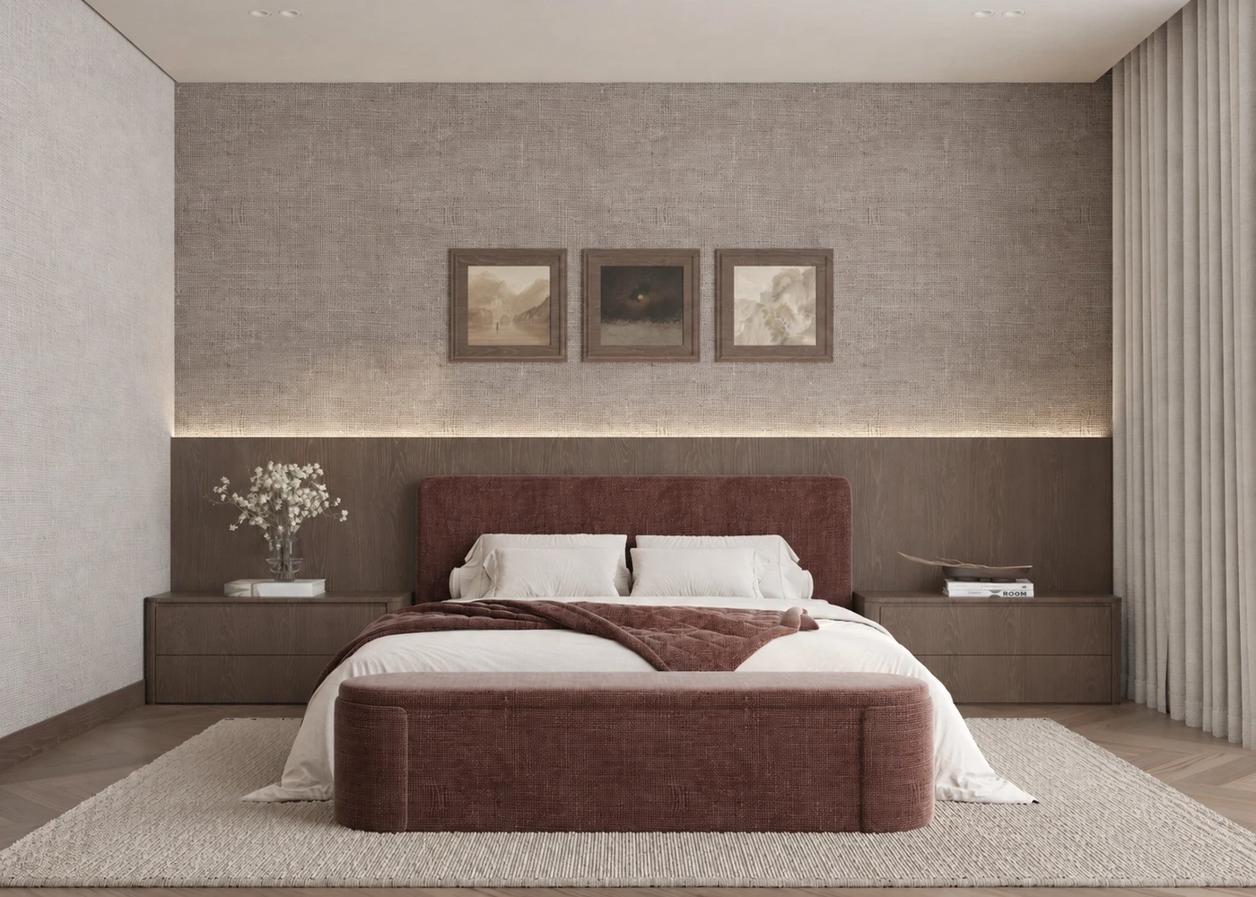Front view of the burgundy bed beneath three framed artworks and concealed light