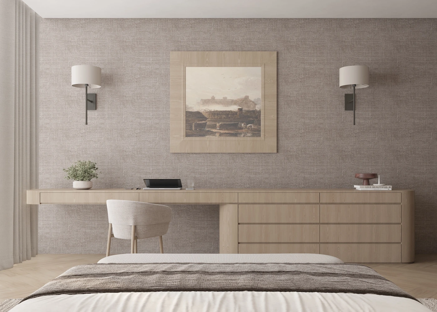 Long bedroom desk with artwork and drawers viewed across the bed
