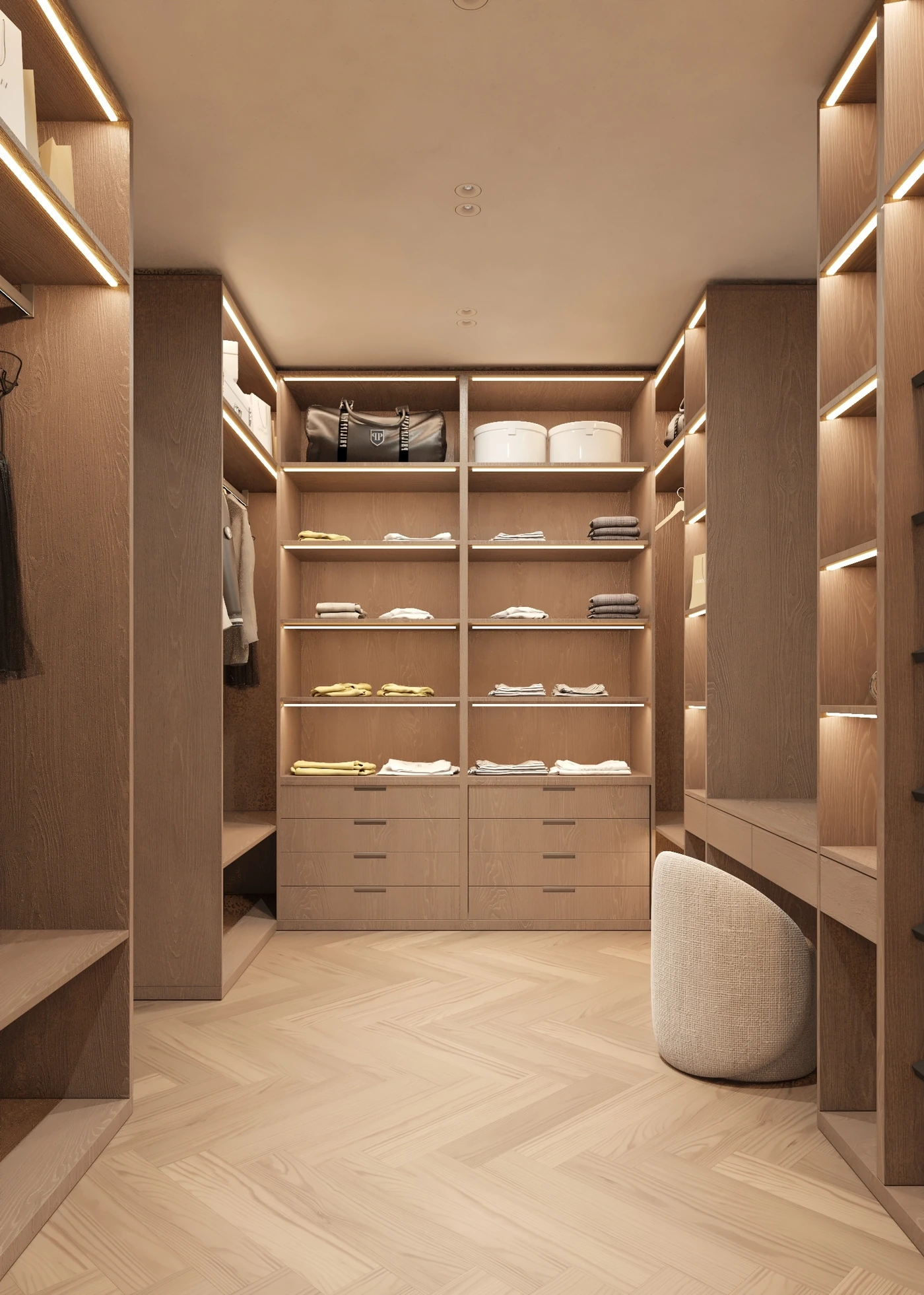 Front view of the illuminated wardrobe wall with folded clothes and drawers